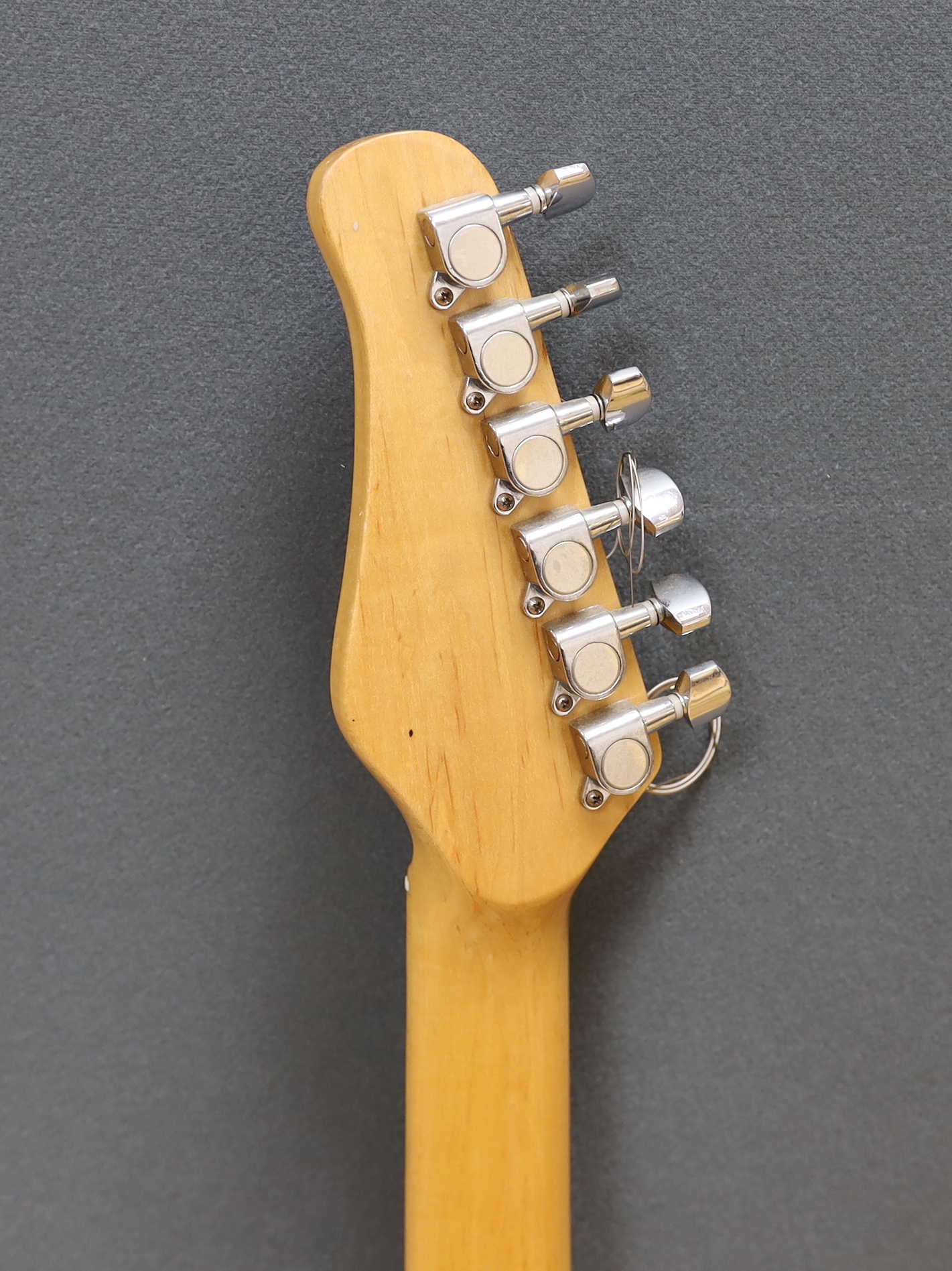 A JCX Stargazer electric guitar with maple neck and orange lacquered body